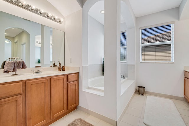 bathroom featuring a tub, tile patterned flooring, and vanity