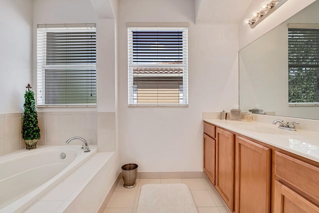 bathroom featuring tile patterned floors, vanity, and tiled tub