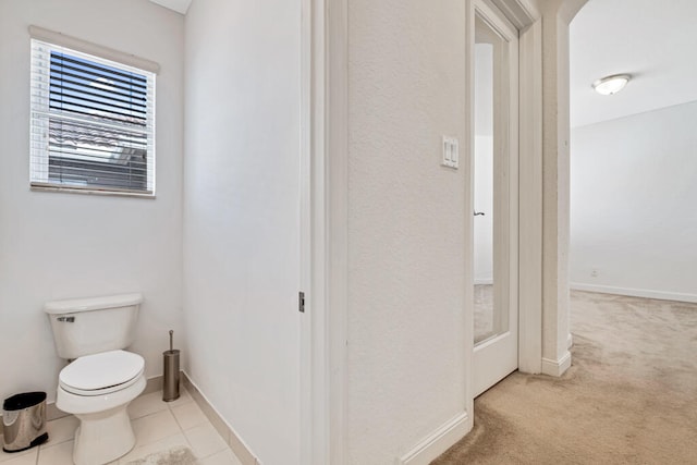 bathroom with tile patterned flooring and toilet