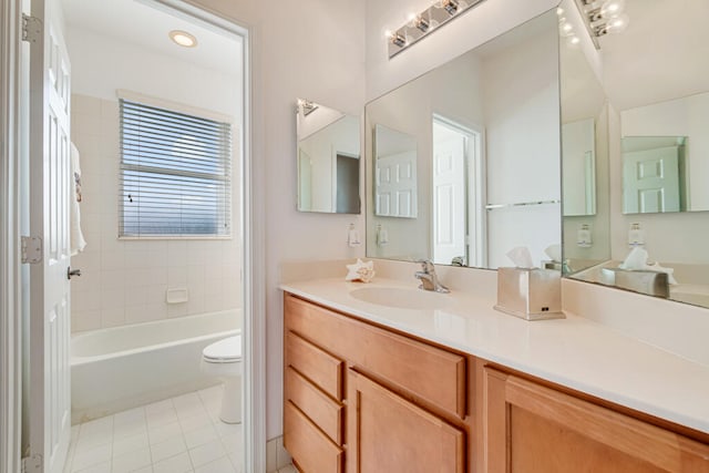 bathroom with tile patterned flooring, a bathtub, vanity, and toilet