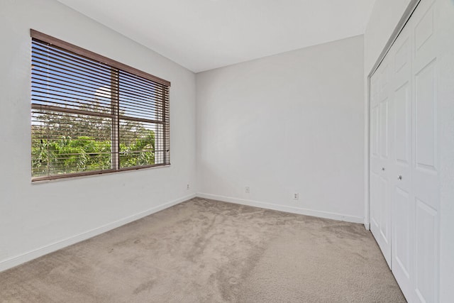 spare room with light colored carpet