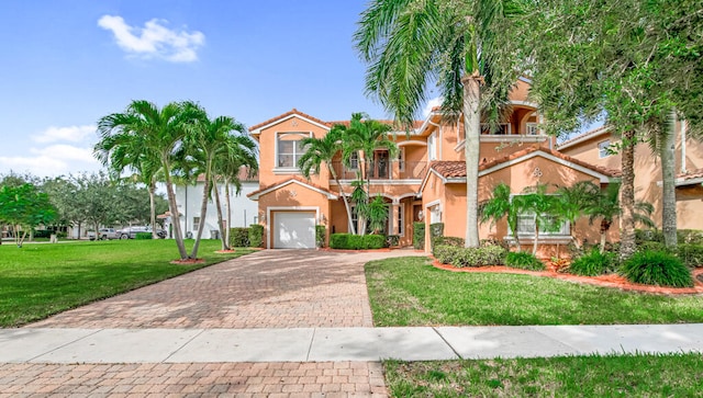 mediterranean / spanish-style home featuring a balcony, a garage, and a front lawn