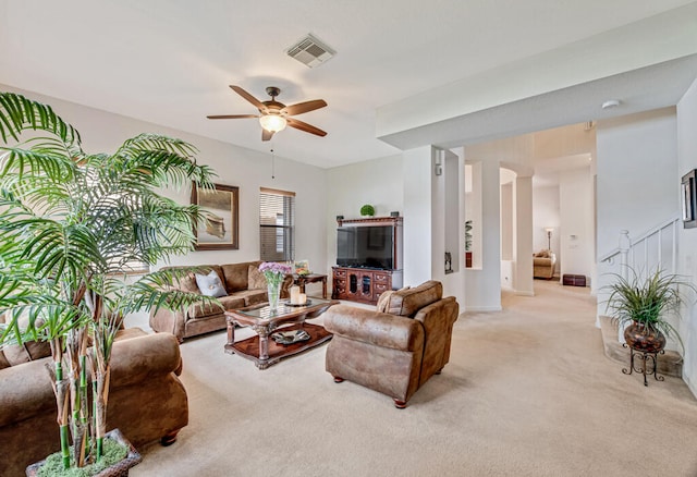 carpeted living room featuring ceiling fan