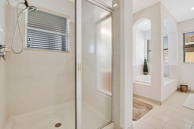 bathroom featuring tile patterned floors and shower with separate bathtub