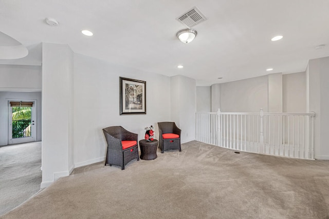 living area featuring light colored carpet