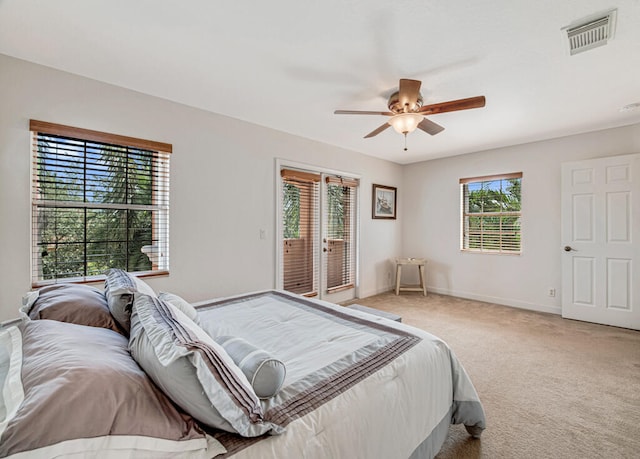 bedroom with access to exterior, carpet flooring, multiple windows, and ceiling fan