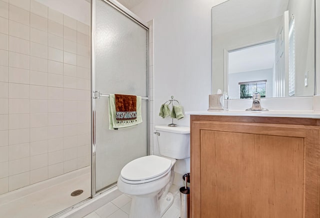 bathroom featuring tile patterned floors, a shower with door, vanity, and toilet