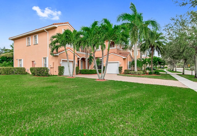 mediterranean / spanish-style house with a front lawn and a garage