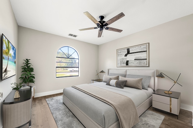 bedroom with ceiling fan and wood-type flooring