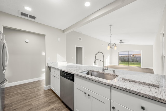 kitchen featuring lofted ceiling with beams, sink, white cabinetry, light stone countertops, and stainless steel appliances