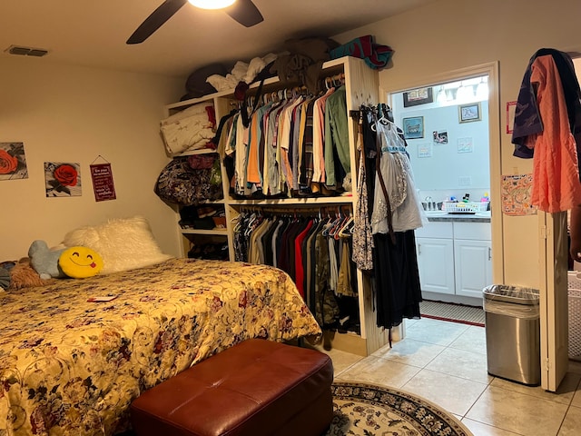 bedroom featuring a closet, ceiling fan, and light tile patterned floors