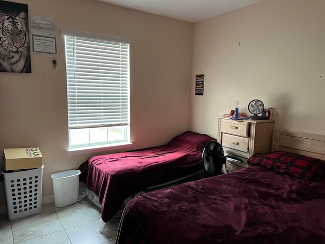 bedroom with multiple windows and light tile patterned floors