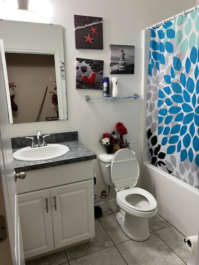 full bathroom featuring toilet, shower / bath combo with shower curtain, vanity, and tile patterned floors