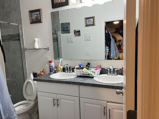 bathroom featuring toilet, walk in shower, and vanity