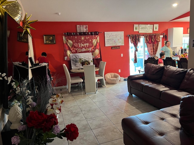 living room featuring lofted ceiling and light tile patterned floors