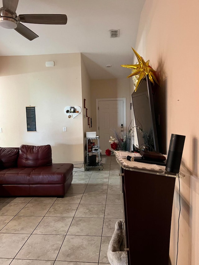 living room featuring light tile patterned floors and ceiling fan