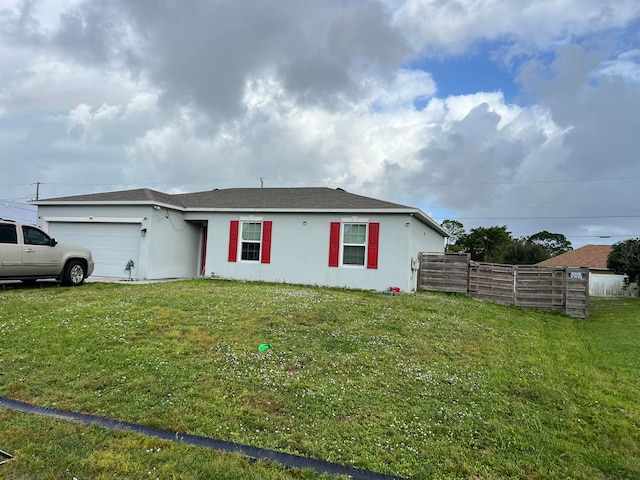 view of front facade featuring a front yard and a garage