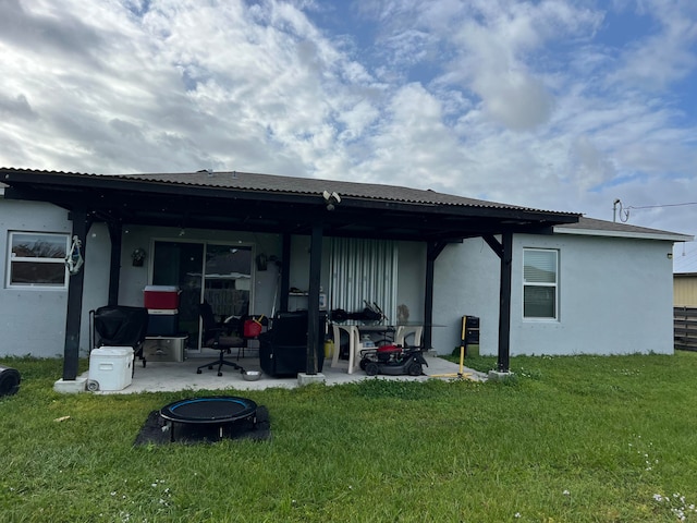 back of house with a patio area, a fire pit, and a yard