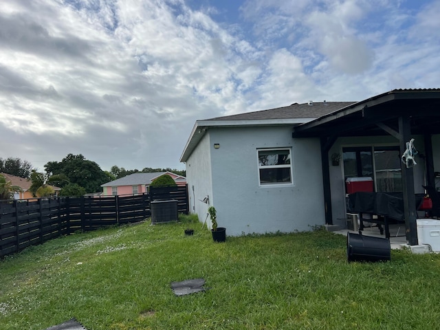 view of side of property with a yard