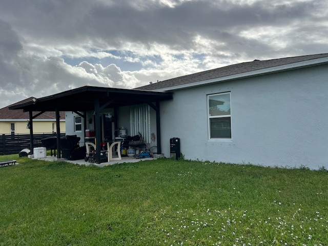 back of house featuring a yard and a patio area