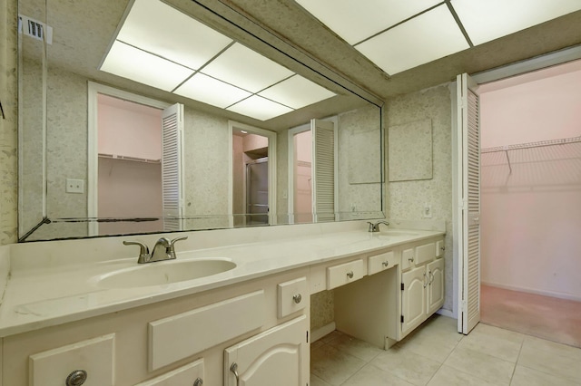 bathroom featuring tile patterned flooring and vanity