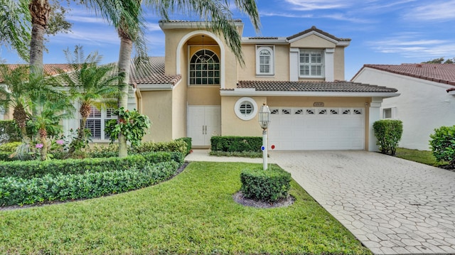 view of front of property with a front yard and a garage