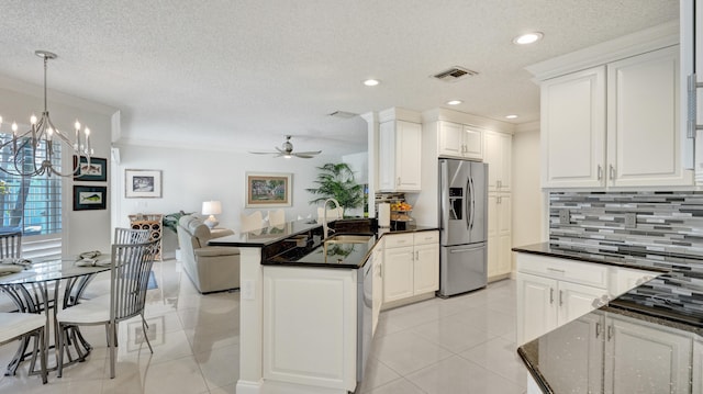 kitchen featuring decorative backsplash, stainless steel appliances, crown molding, sink, and white cabinetry