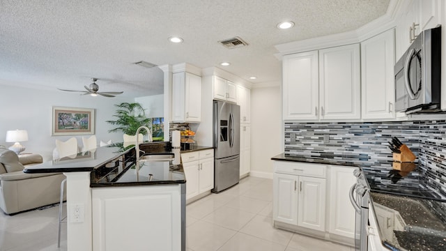 kitchen with white cabinets, sink, and appliances with stainless steel finishes