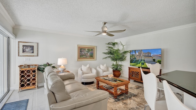 living room featuring a textured ceiling, crown molding, ceiling fan, and a healthy amount of sunlight