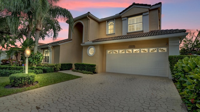 mediterranean / spanish house featuring a garage