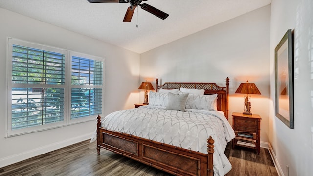 bedroom featuring ceiling fan, dark wood-type flooring, and lofted ceiling