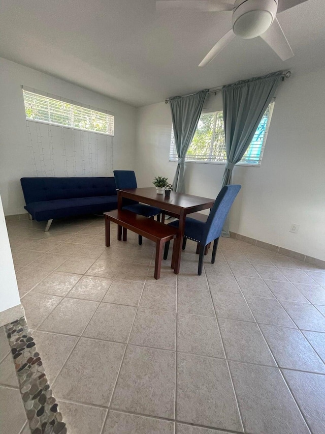 tiled dining area with a wealth of natural light and ceiling fan