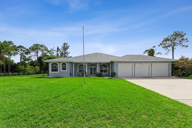 ranch-style house featuring a front lawn and a garage