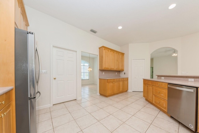 kitchen with light tile patterned floors and stainless steel appliances