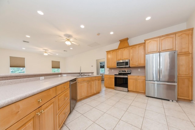 kitchen with sink, a wealth of natural light, stainless steel appliances, and light tile patterned flooring