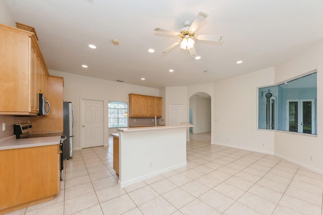 kitchen with light tile patterned floors, ceiling fan, and appliances with stainless steel finishes