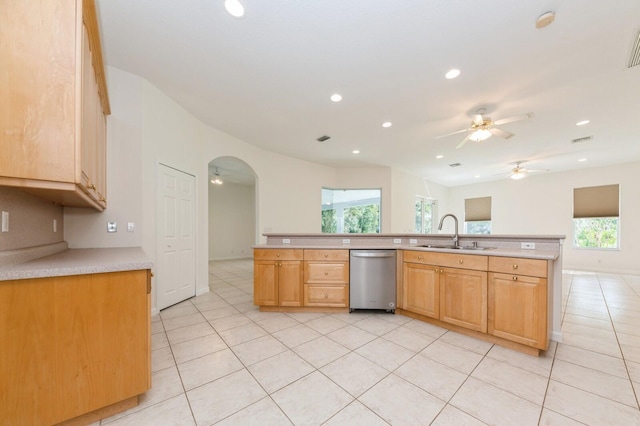 kitchen featuring stainless steel dishwasher, plenty of natural light, sink, and light tile patterned flooring