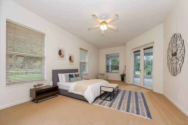 bedroom with ceiling fan, access to exterior, light colored carpet, and french doors