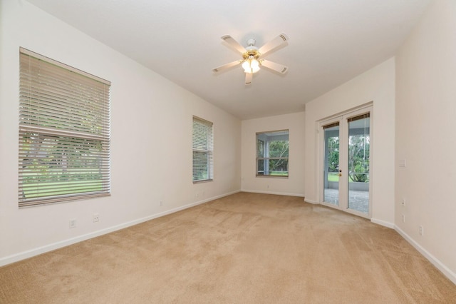 unfurnished room with light carpet, ceiling fan, and french doors