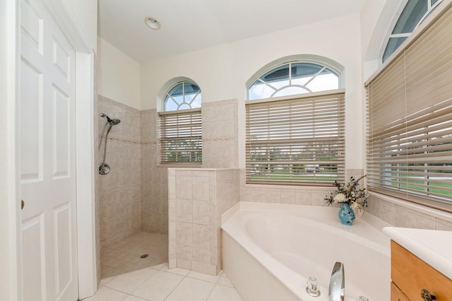 bathroom featuring tile patterned floors, separate shower and tub, and vanity