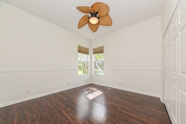 spare room featuring ceiling fan and dark hardwood / wood-style flooring