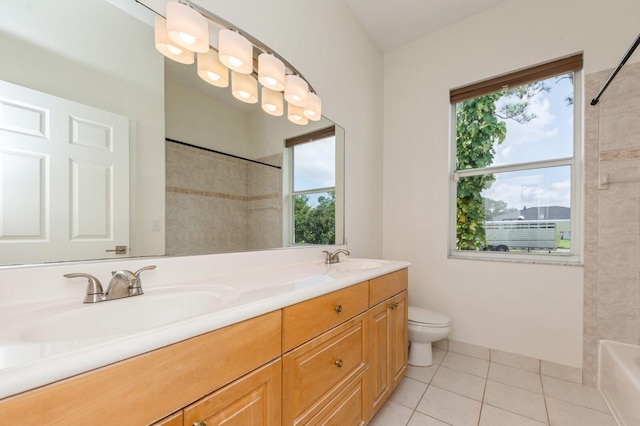 bathroom featuring toilet, tile patterned flooring, a healthy amount of sunlight, and vanity