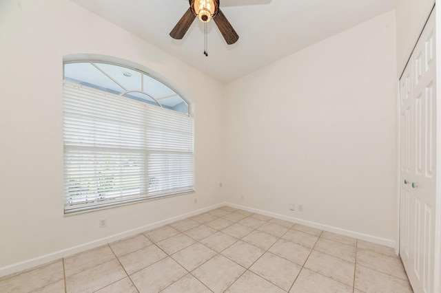 empty room featuring ceiling fan and light tile patterned floors