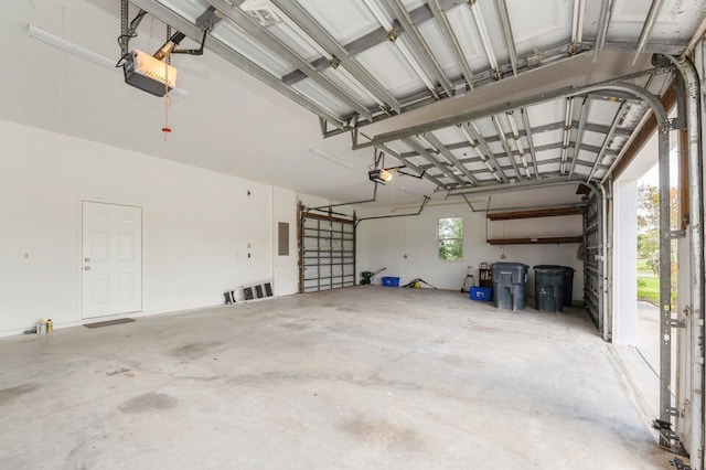 garage with a garage door opener and electric panel