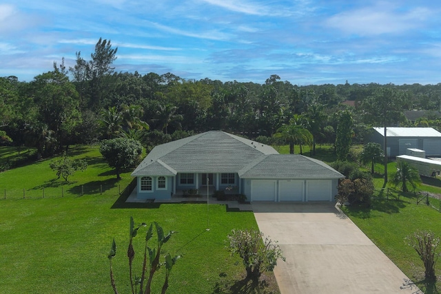 view of front of house with a front yard, covered porch, and a garage