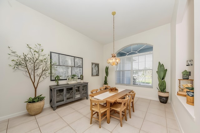 tiled dining area with an inviting chandelier