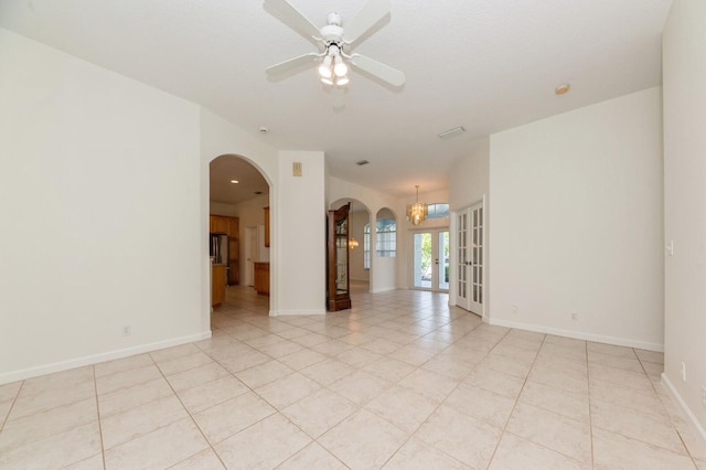 tiled spare room with ceiling fan and french doors