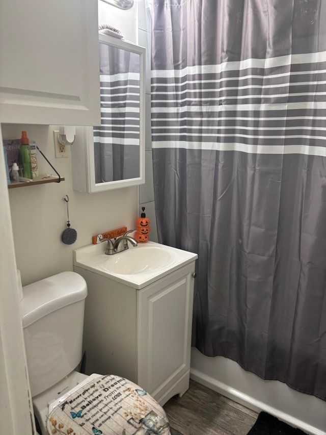 full bathroom featuring vanity, toilet, wood-type flooring, and shower / bath combo