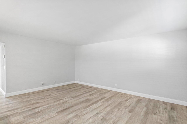 spare room featuring light hardwood / wood-style floors