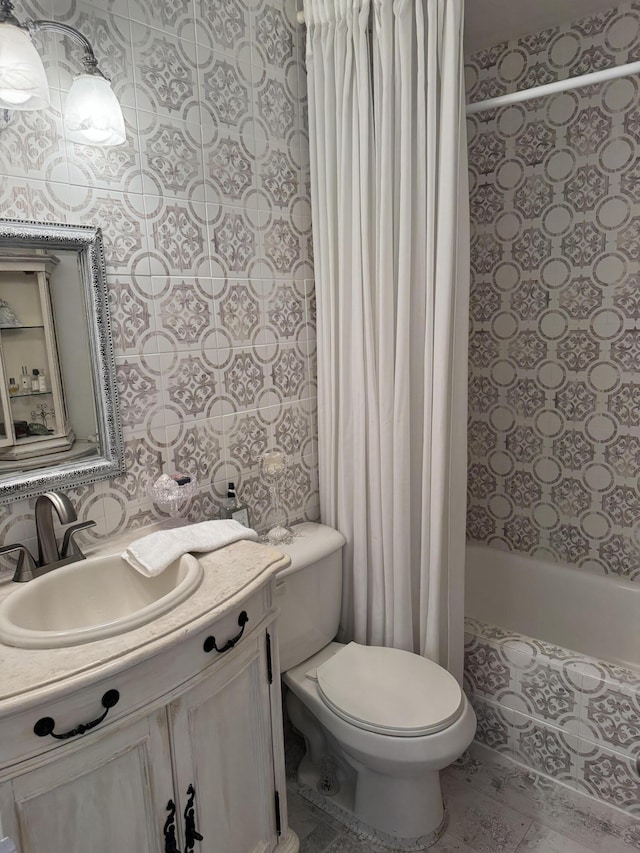 full bathroom featuring toilet, tiled shower / bath, and vanity